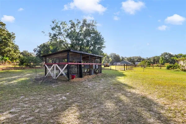 a view of a house with a yard and sitting area