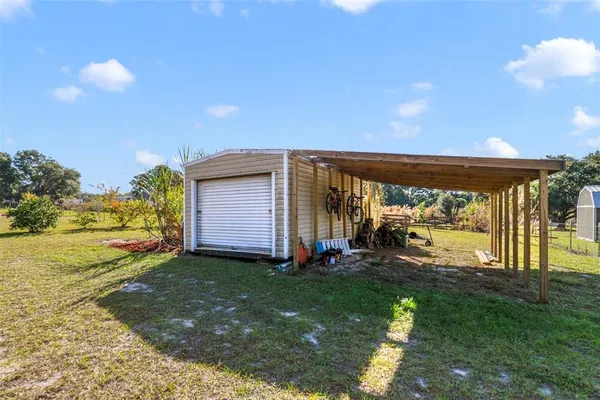 a view of a backyard with floor to ceiling window and wooden fence