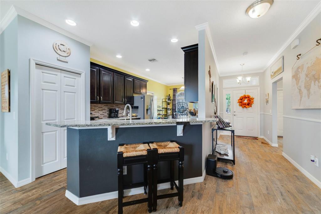 37041 North Thrill Hill Road Eustis, FL 32736 - Photo 5 of 25 a kitchen with stainless steel appliances granite countertop a refrigerator and a stove top oven