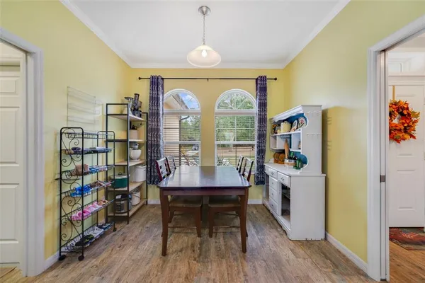 a view of a workspace with furniture and wooden floor