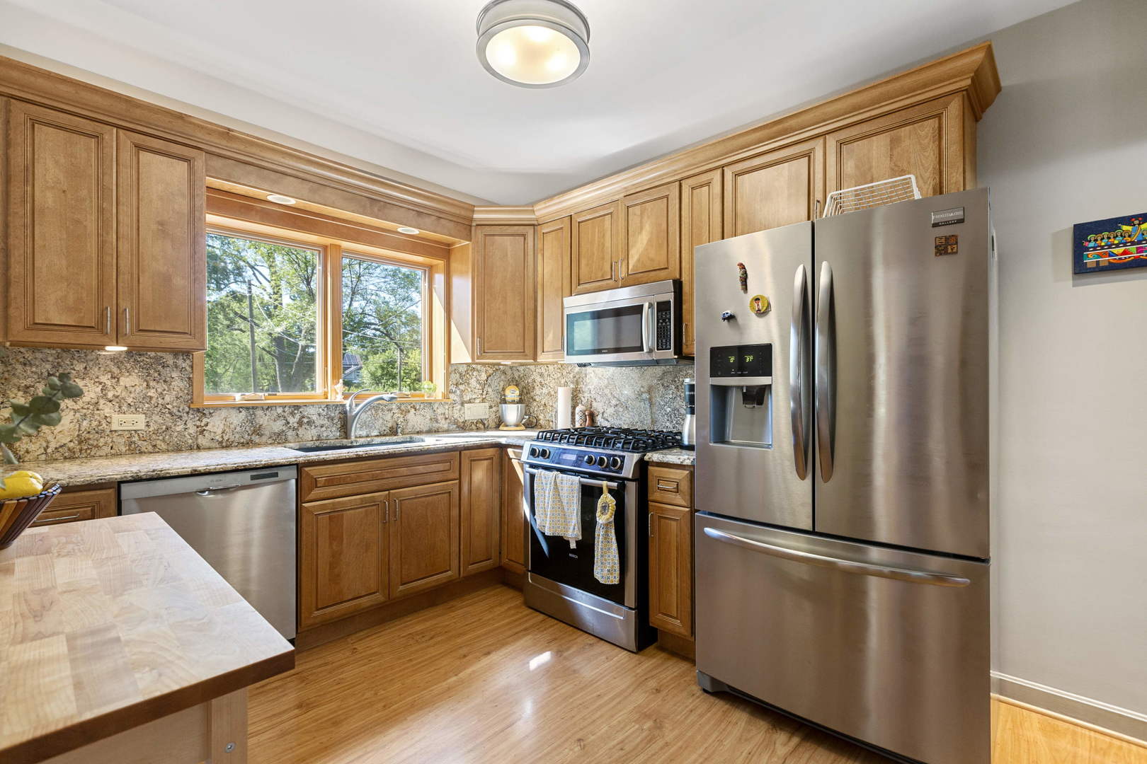 404 Selborne Road Riverside, IL 60546 - Photo 16 of 26 a kitchen with stainless steel appliances granite countertop a refrigerator stove microwave and sink