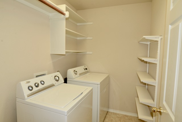 138 Chestnut Court Georgetown, TX 78633 - Photo 25 of 25 A dedicated laundry room with functional shelving and modern appliances for efficient home management.