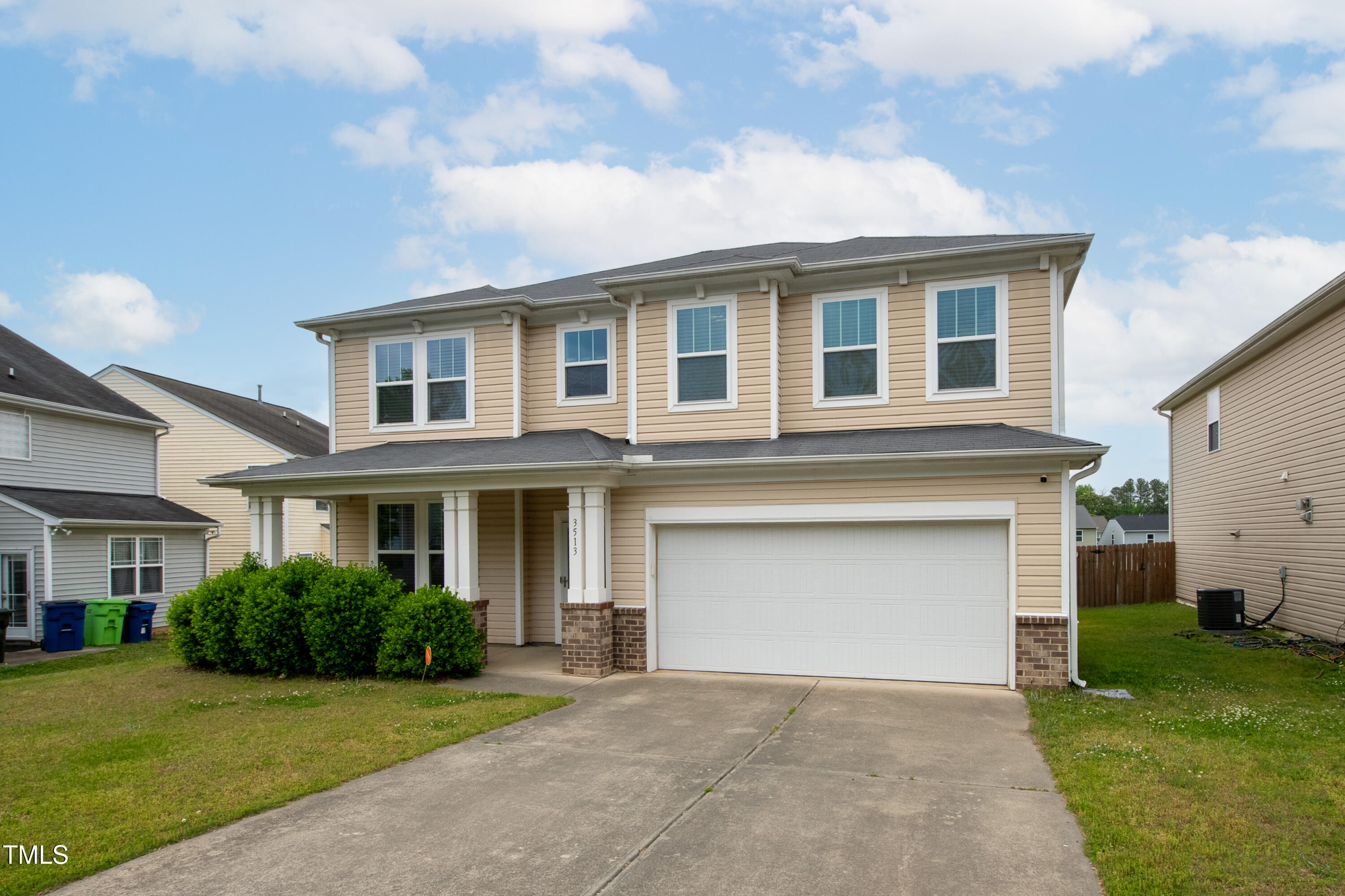 a front view of a house with a garden and yard