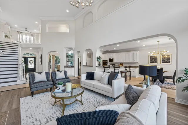 a bedroom with a large bed and a chandelier