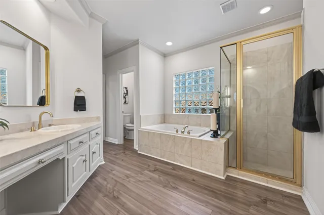 a bathroom with double vanity and a mirror