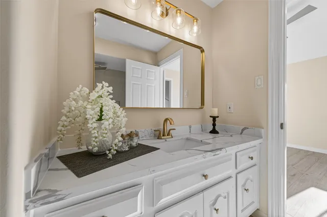 a bathroom with a sink and a mirror