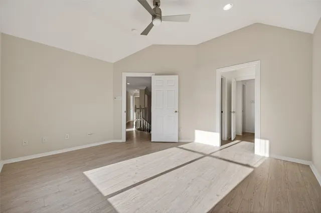 a bedroom with a large bed and a flat screen tv