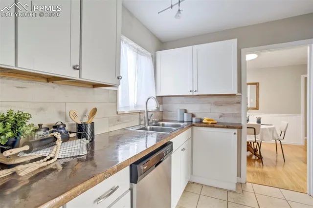 a kitchen with a sink a microwave and cabinets