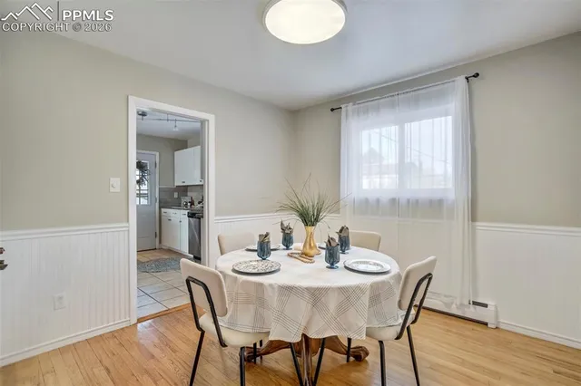 a view of a dining room with furniture window and wooden floor