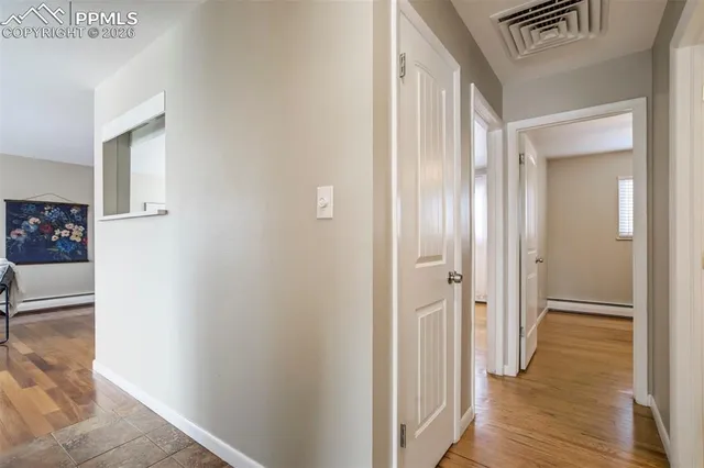 a view of a hallway with wooden floor