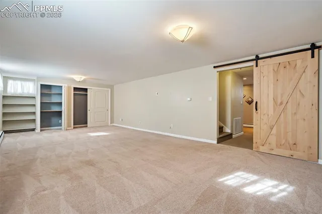 a view of an empty room with a closet