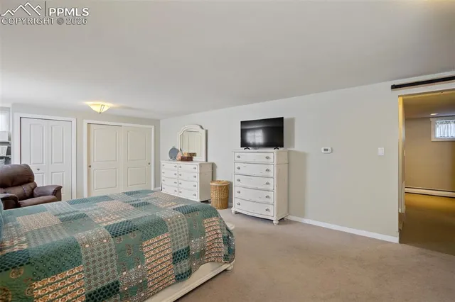 a bedroom with a bed and a television