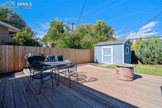 a view of a backyard with sitting area