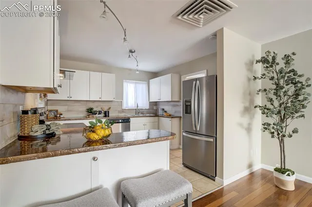 a kitchen with a refrigerator and a sink