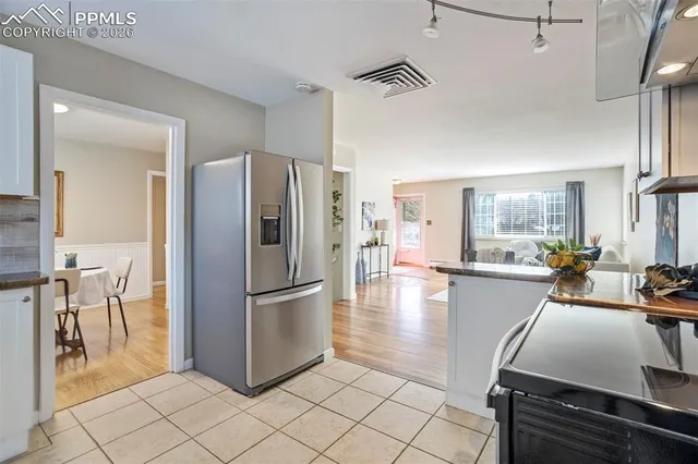 a kitchen with stainless steel appliances a refrigerator and a counter top space