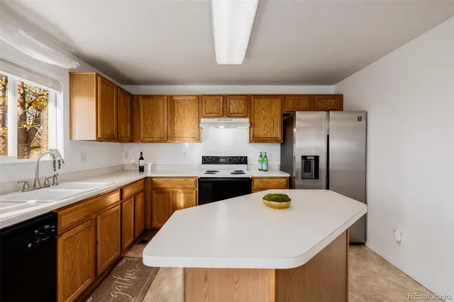 a bathroom with a granite countertop sink toilet and a mirror