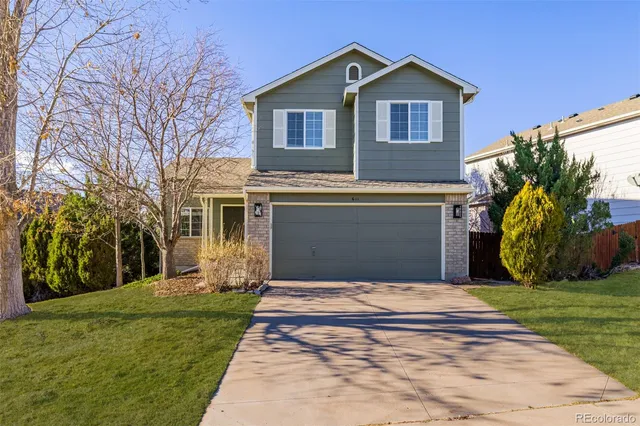a living room with furniture a fireplace and a floor to ceiling window