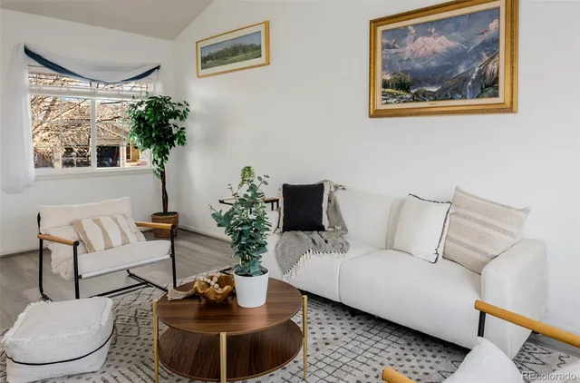 a living room with furniture a window and a fireplace