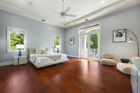 a bedroom with furniture and wooden floor