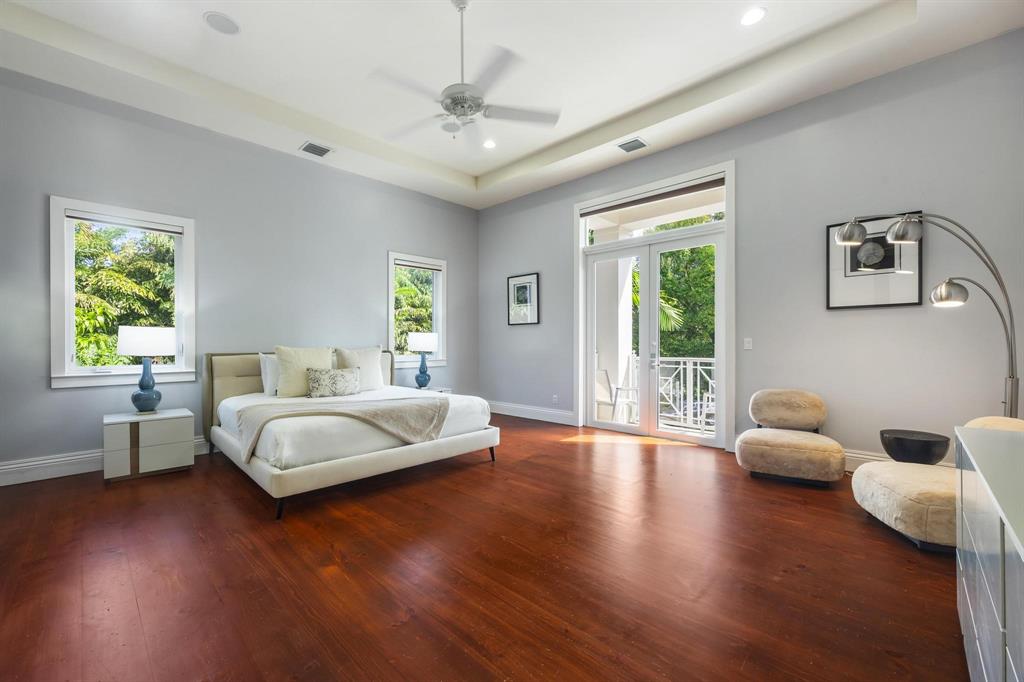 101 Holly Lane Plantation, FL 33317 - Photo 28 of 59 a bedroom with a bed and wooden floor