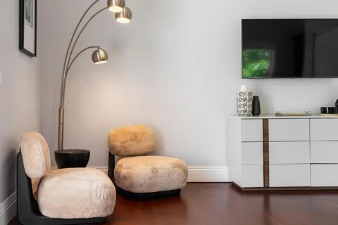 a bedroom with a bed and a potted plant