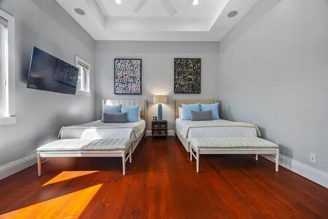 a bedroom with a bed and a flat screen tv