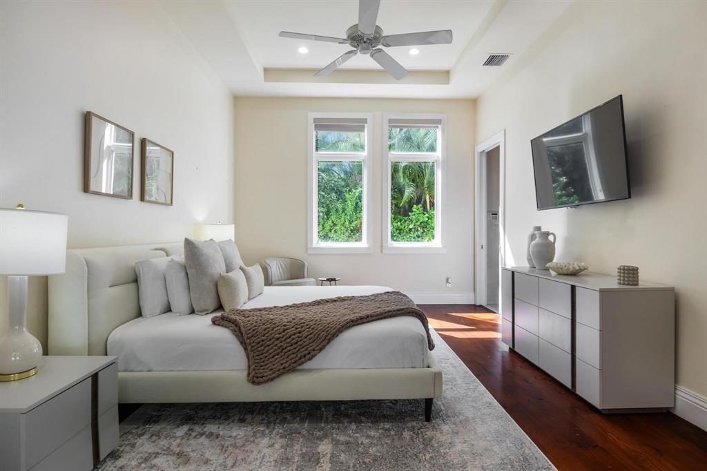 101 Holly Lane Plantation, FL 33317 - Photo 35 of 59 a bedroom with a bed a flat screen tv and window