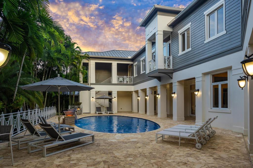 101 Holly Lane Plantation, FL 33317 - Photo 50 of 59 a view of a patio with table and chairs under an umbrella