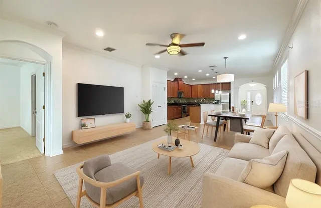 a view of a house with a big yard plants and large tree