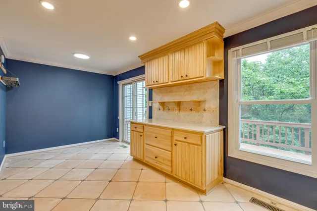 a kitchen with granite countertop cabinets and window