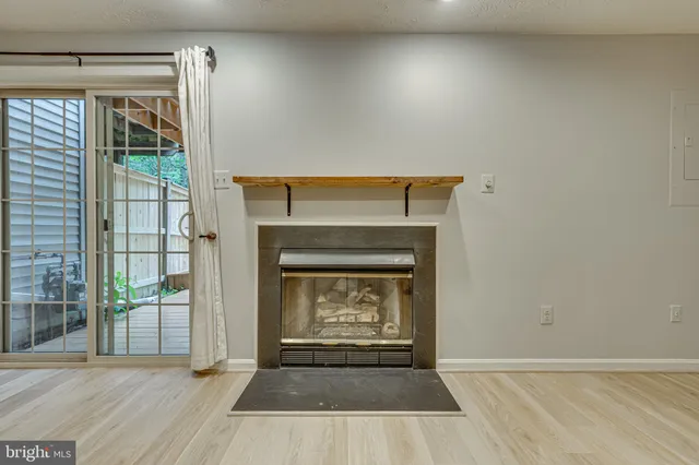 an empty room with a fireplace and windows