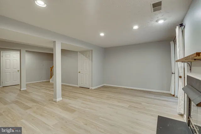 wooden floor in an empty room with a fireplace