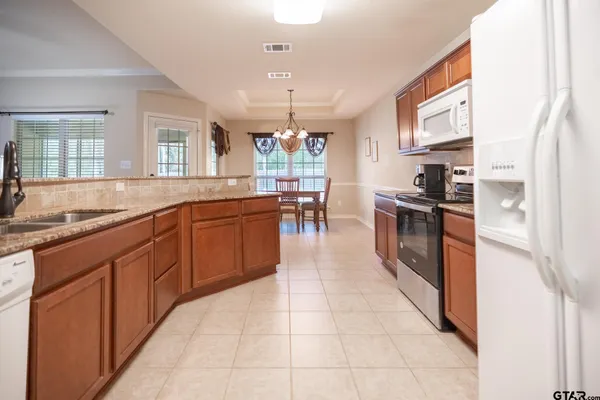 a view of a dining room with furniture wooden floor and chandelier