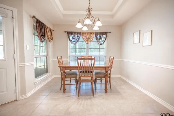 a view of a hallway with wooden floor and a bathroom
