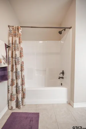 a bathroom with a glass shower door