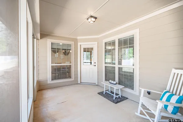 a front view of a house with a yard and potted plants