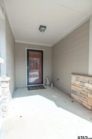 an empty room with a piano and wooden floor