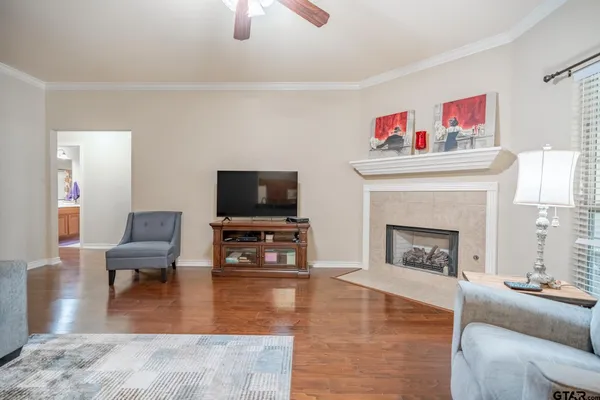 a living room with furniture a fireplace and a flat screen tv