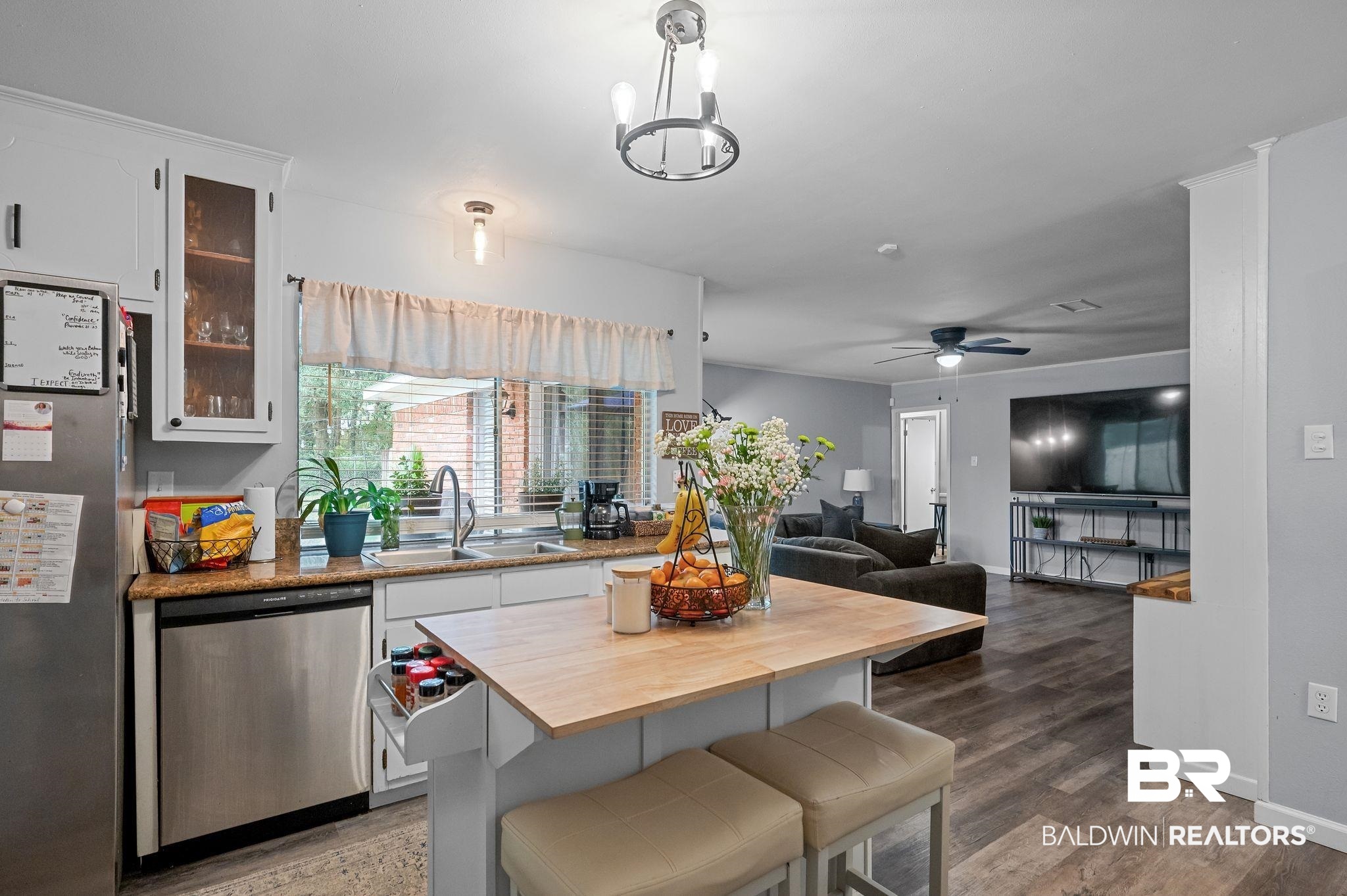 4724 Wicker Way Mobile, AL 36609 - Photo 14 of 36 Kitchen featuring white cabinetry, stainless steel appliances, and a light-toned wood island with seating