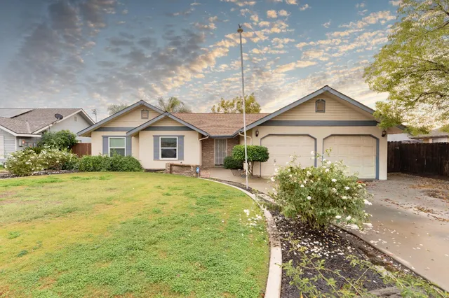 a front view of a house with a garden