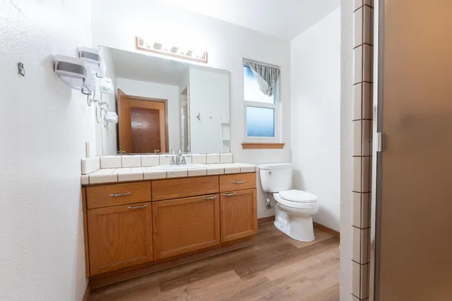 a bathroom with a toilet sink and mirror