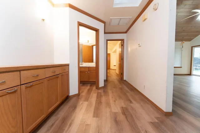 a view of a hallway with wooden floor