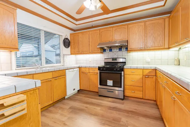 a kitchen with stainless steel appliances granite countertop a stove and a sink