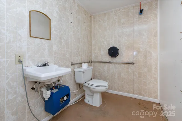 a bathroom with a granite countertop toilet and a sink