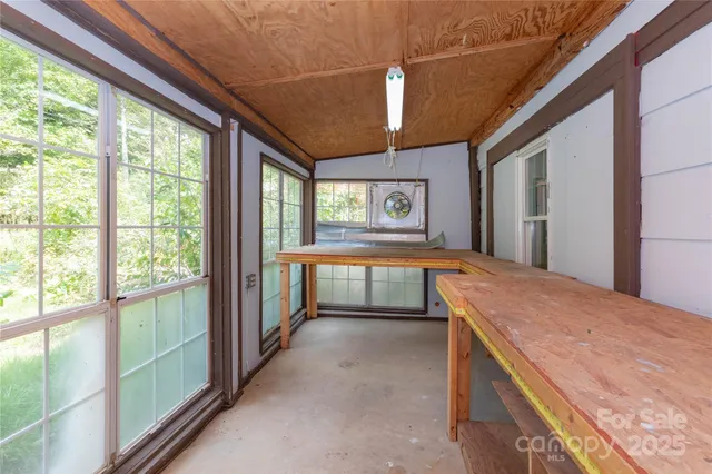 an empty room with windows and closet