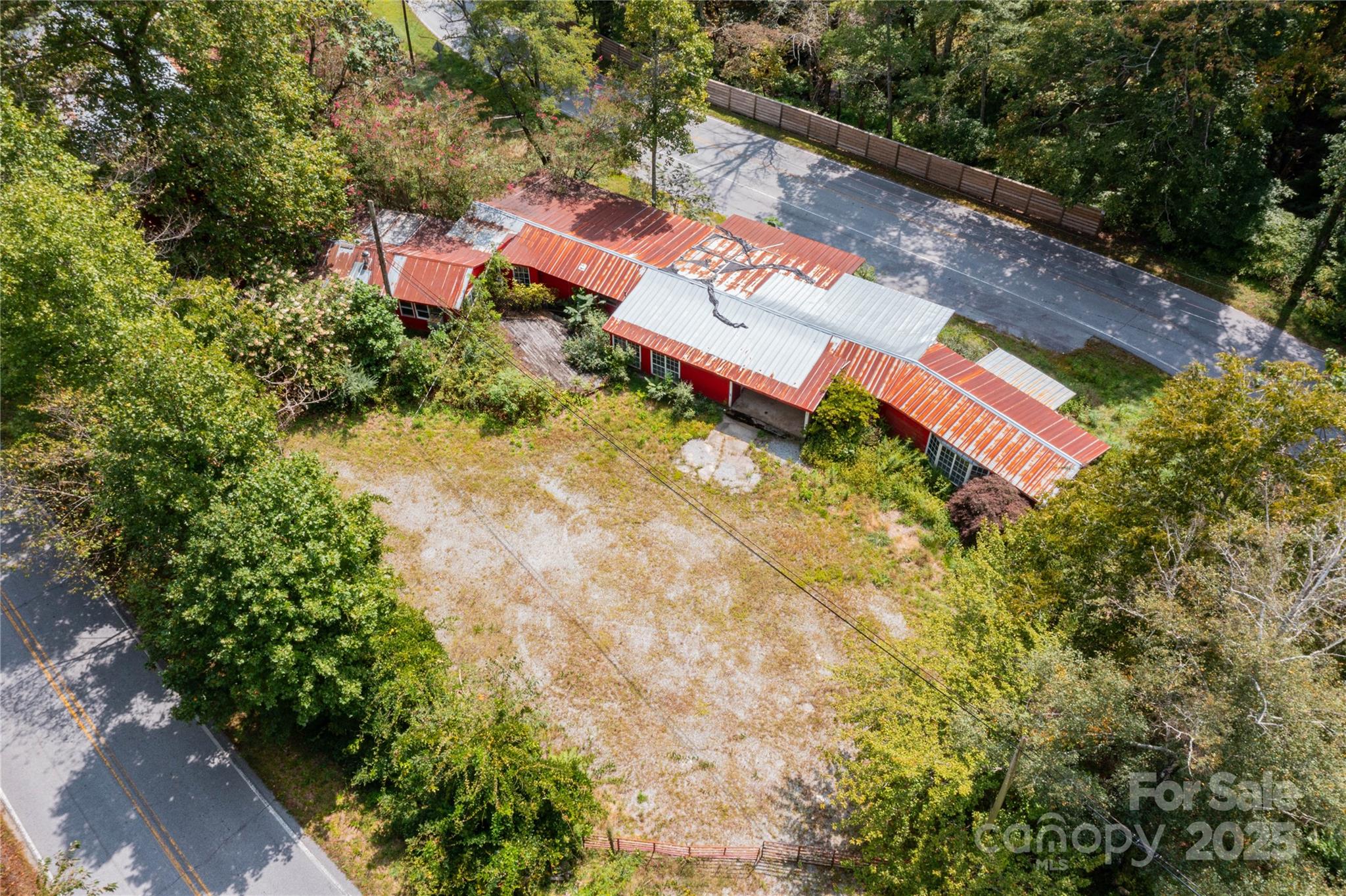 3290 Gerton Highway Gerton, NC 28735 - Photo 36 of 36 an aerial view of a house with swimming pool and red chairs