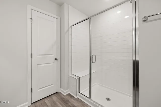 a bathroom with a glass shower door