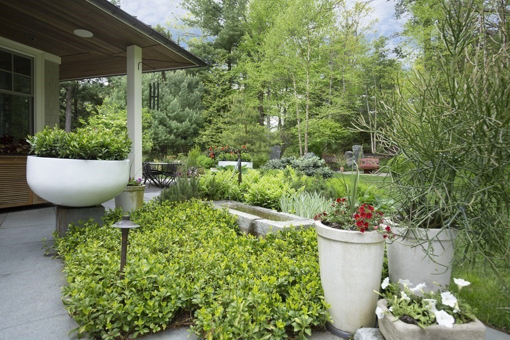 55 Ridge Hill Farm Road Wellesley, MA 02482 - Photo 25 of 32 a view of a garden with plants and a fountain