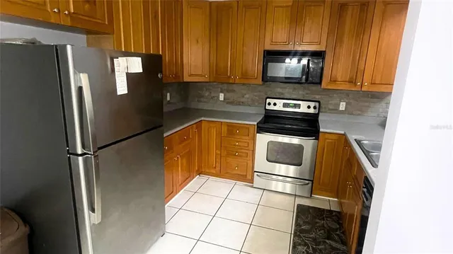 a kitchen with a refrigerator stove and microwave