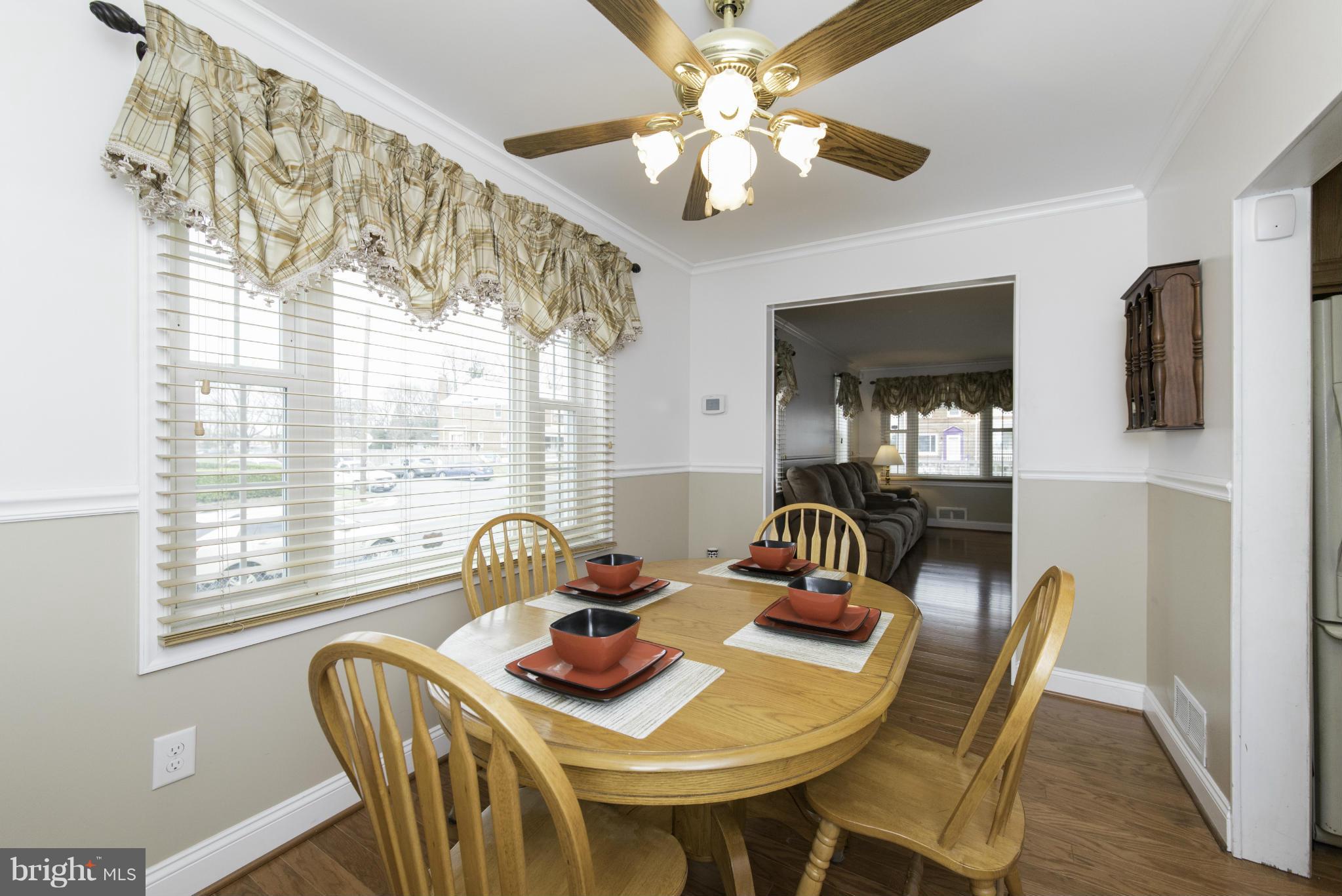 1900 Barry Road Baltimore, MD 21222 - Photo 12 of 30 a dining room with furniture a chandelier and window